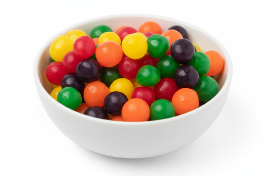 Assorted colorful gumballs on a white bowl